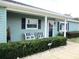 Charming front porch with blue accents, seating, and well-maintained landscaping at 11792 Sw 137Th Loop, Dunnellon, FL 34432