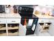 Updated kitchen featuring white cabinets, modern appliances, and custom drawer inserts at 11792 Sw 137Th Loop, Dunnellon, FL 34432