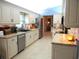 Open kitchen featuring white cabinets, stainless steel appliances, and granite countertops at 11792 Sw 137Th Loop, Dunnellon, FL 34432