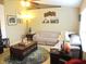 Bright living room with a large sectional sofa, wood flooring, and stylish decor at 11792 Sw 137Th Loop, Dunnellon, FL 34432