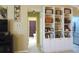 Inviting living room featuring open floor plan with built-in shelving and view to the bathroom at 11792 Sw 137Th Loop, Dunnellon, FL 34432