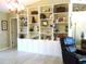Well-lit living room with custom built-in shelving and a comfortable recliner at 11792 Sw 137Th Loop, Dunnellon, FL 34432