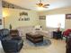 Inviting living room with comfortable seating, a ceiling fan, and light colored floors at 11792 Sw 137Th Loop, Dunnellon, FL 34432