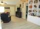 Open living room featuring custom built-in shelving and a cozy fireplace at 11792 Sw 137Th Loop, Dunnellon, FL 34432