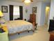 This main bedroom offers a ceiling fan, carpet, and a full furniture set at 11792 Sw 137Th Loop, Dunnellon, FL 34432