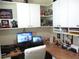 Home office features custom cabinetry, workspace, and display shelving at 11792 Sw 137Th Loop, Dunnellon, FL 34432