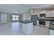 Open kitchen layout with stainless steel appliances and a center island at 12805 Sw 38Th Cir, Ocala, FL 34473