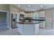 Modern kitchen with stainless steel appliances, white cabinets, and a granite island at 12805 Sw 38Th Cir, Ocala, FL 34473