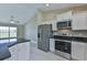Close up of the modern stainless steel appliances and white cabinets in the kitchen at 12805 Sw 38Th Cir, Ocala, FL 34473