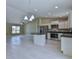 Bright, open kitchen with stainless steel appliances, granite countertops, and tile flooring at 12805 Sw 38Th Cir, Ocala, FL 34473