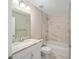 Bathroom featuring granite countertop, a large mirror and a tub with shower at 13180 Sw 80Th St, Dunnellon, FL 34432