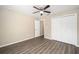 Bedroom with hardwood floors, ceiling fan, closet and doorway at 13180 Sw 80Th St, Dunnellon, FL 34432