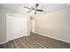 Bedroom with hardwood floors, ceiling fan, closet and a doorway at 13180 Sw 80Th St, Dunnellon, FL 34432