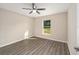 Bright bedroom with hardwood floors, ceiling fan, and a window looking out on greenery at 13180 Sw 80Th St, Dunnellon, FL 34432