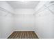 Bright walk-in closet featuring white walls, wood-look flooring, and wire shelving at 13180 Sw 80Th St, Dunnellon, FL 34432