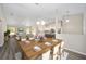 Open-concept dining area with view to living room and modern kitchen at 13180 Sw 80Th St, Dunnellon, FL 34432