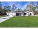 Beautiful one-story home with a well-manicured lawn and a two-car garage at 13180 Sw 80Th St, Dunnellon, FL 34432