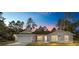 Charming single-story home featuring a two-car garage and beautiful landscaping at 13180 Sw 80Th St, Dunnellon, FL 34432