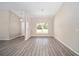 Open concept living and dining area featuring stylish gray wood-look flooring and lots of natural light at 13180 Sw 80Th St, Dunnellon, FL 34432
