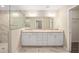 Bathroom with double sink vanity, tile floors, framed mirrors, and glass shower stall at 13180 Sw 80Th St, Dunnellon, FL 34432