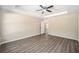 Large main bedroom with tray ceiling, ceiling fan, and wood-look flooring at 13180 Sw 80Th St, Dunnellon, FL 34432