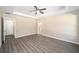 Spacious main bedroom with tray ceiling, wood-look floors, and ensuite bathroom at 13180 Sw 80Th St, Dunnellon, FL 34432