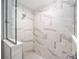 Beautiful shower with white and grey marble tiling and rainfall showerhead at 13180 Sw 80Th St, Dunnellon, FL 34432