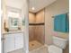 Bathroom featuring modern fixtures, updated vanity, granite countertop, and a walk-in tiled shower at 14451 Sw 76Th Avenue Rd, Ocala, FL 34473