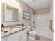 Bright bathroom features a granite countertop vanity, framed mirror, and a shower over tub at 15428 Sw 60Th Cir, Ocala, FL 34473