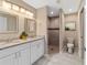 Modern bathroom features double sinks, granite countertops, and a walk-in tiled shower at 15428 Sw 60Th Cir, Ocala, FL 34473