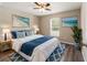 Comfortable bedroom featuring a large window, ceiling fan, and cozy rug on laminate floors at 15428 Sw 60Th Cir, Ocala, FL 34473