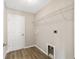Spacious laundry room featuring laminate wood flooring, wire rack storage, and utility connections at 15428 Sw 60Th Cir, Ocala, FL 34473