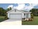 Charming one-story home with a two-car garage, well-manicured lawn, and beautifully landscaped front yard at 2159 Ne 28Th Ln, Ocala, FL 34470
