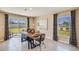 Dining room features a large wood table, bench seating, and a sliding glass door to the backyard at 2163 Ne 28Th Ln, Ocala, FL 34470