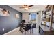 Well-lit home office with dark accent wall, modern desk, and view from the large window at 2163 Ne 28Th Ln, Ocala, FL 34470