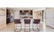 Modern kitchen boasts stainless steel appliances, dark cabinets, and a center island with bar stool seating at 2163 Ne 28Th Ln, Ocala, FL 34470