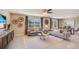 Spacious living room featuring modern decor, neutral tones, tile floors, and lots of natural light at 2163 Ne 28Th Ln, Ocala, FL 34470