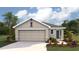 Charming single-story home featuring a two-car garage, neutral stucco siding, and freshly manicured landscaping at 2164 Ne 28Th Ln, Ocala, FL 34470