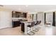 Stylish kitchen with dark cabinets, stainless steel appliances, and an island with seating for casual dining at 2170 Ne 28Th Ln, Ocala, FL 34470