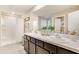 Elegant main bathroom with double vanity, walk-in shower, and modern fixtures for a luxurious experience at 2170 Ne 28Th Ln, Ocala, FL 34470