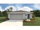 Charming single-story home with a two-car garage and landscaped front yard at 2928 Ne 21St Terrace Rd, Ocala, FL 34470