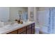 Bathroom featuring double sinks, granite countertop, framed wall art, with neutral color palette at 2940 Ne 21St Terrace Rd, Ocala, FL 34470