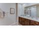 Bathroom featuring double vanity with solid surface counters, framed wall art, and neutral color palette at 2940 Ne 21St Terrace Rd, Ocala, FL 34470