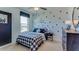 Bedroom featuring an accent wall with star decals, complemented by a window, bed, and nightstand at 2940 Ne 21St Terrace Rd, Ocala, FL 34470