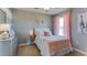 Bedroom styled with pink accents, a comfortable bed, side table, giraffe art, and a window at 2940 Ne 21St Terrace Rd, Ocala, FL 34470