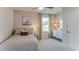 Bedroom with neutral decor, a comfortable bed, and a window with decorative curtains allowing natural light at 2940 Ne 21St Terrace Rd, Ocala, FL 34470