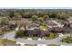 Aerial view of townhome community featuring mature trees, manicured lawns and winding streets at 3616 Ne 17Th Ln, Ocala, FL 34470