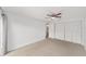 Neutral bedroom with a ceiling fan and multiple closets at 3616 Ne 17Th Ln, Ocala, FL 34470