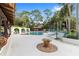 Inviting community pool featuring ample seating, lush landscaping, and a serene atmosphere at 3616 Ne 17Th Ln, Ocala, FL 34470