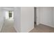 Neutral hallway with carpet flooring, connecting the living spaces with a convenient closet and ample natural light at 3616 Ne 17Th Ln, Ocala, FL 34470